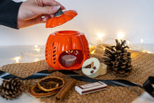 Load image into Gallery viewer, Orange ceramic pumpkin wax melt burner with lit tealight, wax melts, cinnamon and dried orange slices
